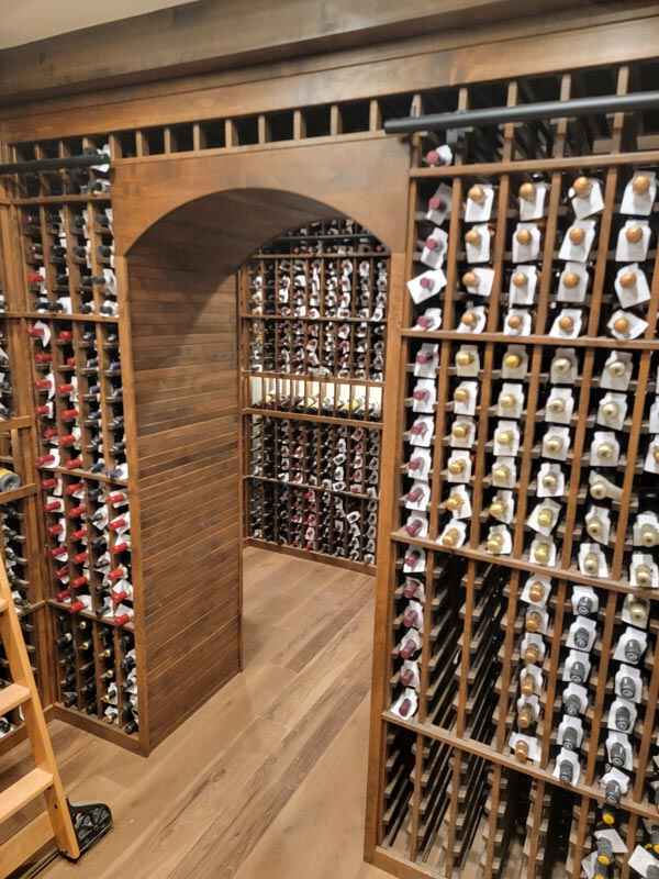 Cozy wine cellar with wooden shelves and assorted bottles in Larkspur, CO.