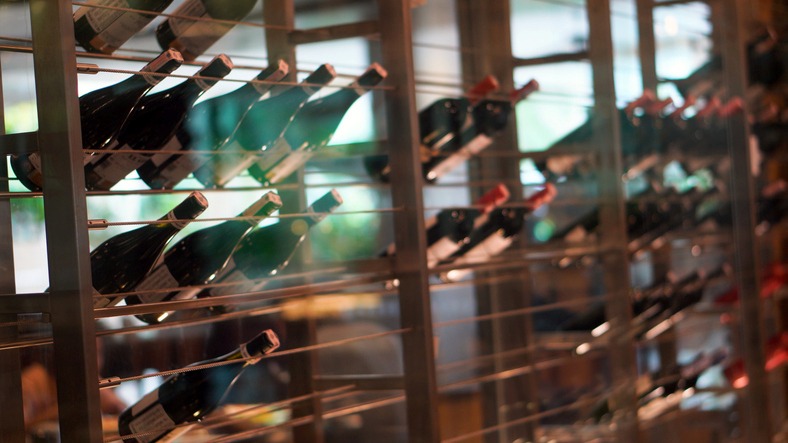 Wine bottles stored horizontally on metal racks in the Denver Metro Area